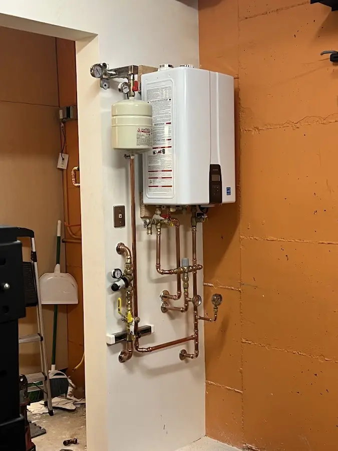 Plumbing technician inspecting water heater connections in Leavenworth